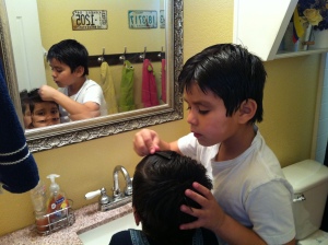 Don't worry. It's not lice. He's showing Oscar how to look nice for the ladies.